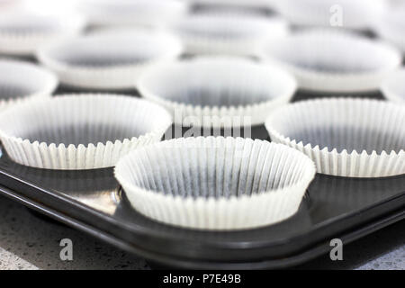 Empty paper forms for muffins and cupcakes in a metal tray Stock Photo