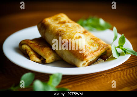 fried thin pancakes stuffed on a plate Stock Photo