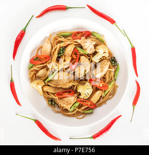 Plate of wok or stir fry noodles with meat and vegetables over wooden ...
