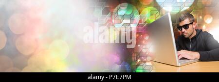 Man with sunglasses using laptop with geometric transitions Stock Photo