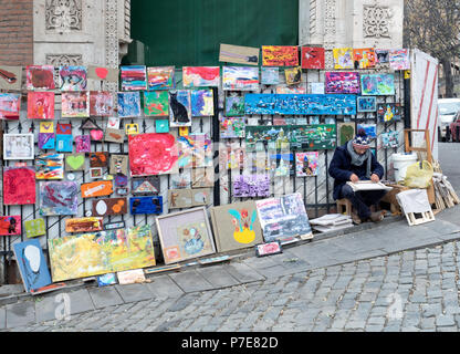 Tbilisi, Georgia - December 5, 2016 : street painter exhibition along a cobblestone alley in Old Town Stock Photo