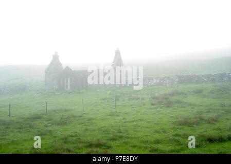Abandoned crofter's house in thick mist, Shetland Islands, Scotland, UK Stock Photo