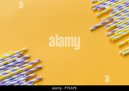 Striped drink straws of different colors in row isolated on white background Stock Photo