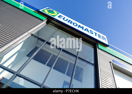 Euromaster sign at garage. Euromaster offers tire services and vehicle maintenance across Europe and is a subsidiary of the tire maker Michelin. Stock Photo