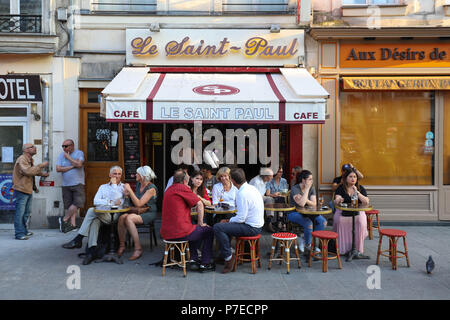 View of typical French cafe Saint Paul in the quarter Marais, the historic Parisian district set on the Right Bank . Stock Photo