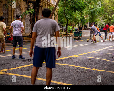 Mumbai, India - June 24, 2018 : Boys playing cricket on streets at Ballard Estate, South Mumbai Stock Photo