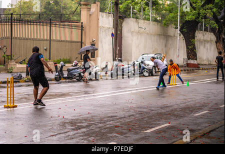 Mumbai, India - June 24, 2018 : Boys playing cricket on streets at Ballard Estate, South Mumbai Stock Photo