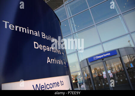 Blue advice signs outside the main doors at Doncaster Sheffield Airport, formerly named Robin Hood Airport Doncaster Sheffield, Stock Photo