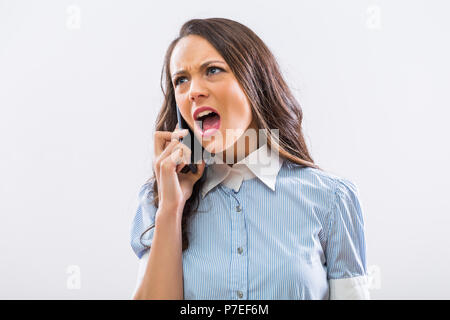 Angry businesswoman on the phone shouting. Stock Photo