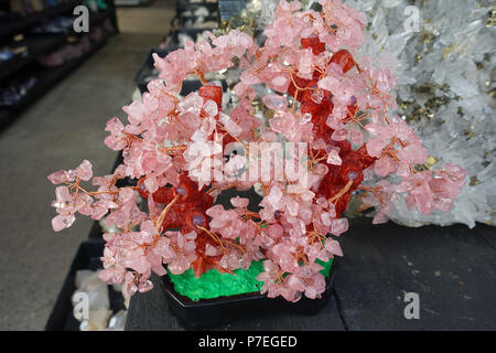 Rose Quartz crystal gemstone trees on display Stock Photo