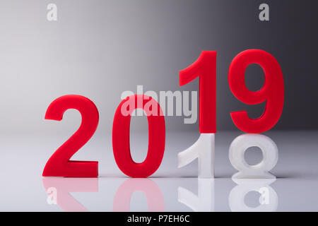 Year 2019 Replaced With Old Year 2018 Over Reflective Background Stock Photo