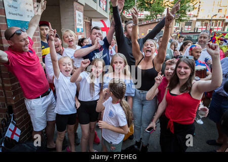 England fans from the Kirby estate in Bermondsey celebrate England team scoring whilst watch the FIFA 2018 World Cup match England vs Colombia. Stock Photo