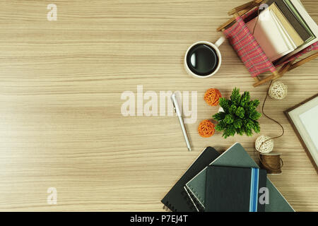 Stack of books with greeting cards and coffee on wood background. Nostalgia rustic with copy space. Stock Photo