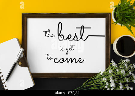 Wood frame with motivational and inspirational wisdom quote on yellow and black background. The best is yet to come. Stock Photo