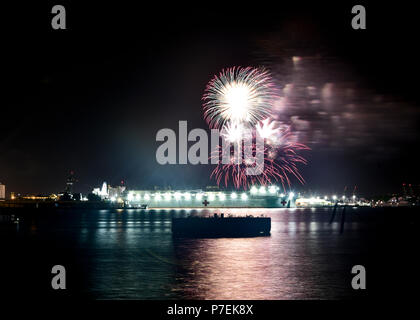 180704-N-HK946-1028 PEARL HARBOR (July 4, 2018) Fireworks burst over Military Sealift Command (MSC) hospital ship USNS Mercy (T-AH 19) at Joint Base Pearl Harbor-Hickam during Rim of the Pacific (RIMPAC) exercise. Twenty-five nations, 46 ships, five submarines, about 200 aircraft and 25,000 personnel are participating in RIMPAC from June 27 to Aug. 2 in and around the Hawaiian Islands and Southern California. The world’s largest international maritime exercise, RIMPAC provides a unique training opportunity while fostering and sustaining cooperative relationships among participants critical to  Stock Photo