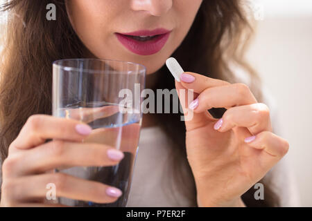 Close-up Of A Businesswoman's Hand Taking Pill Stock Photo