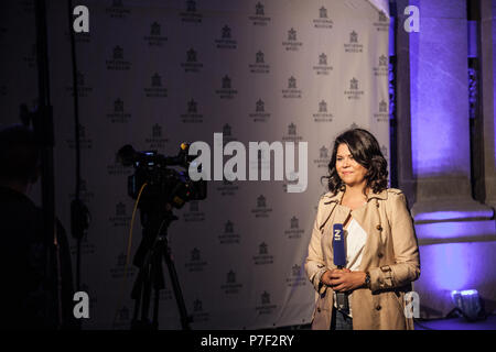 BELGRADE, SERBIA - JUNE 28, 2018: N1 TV anchor reporting from the city center of Belgrade at night. N1 is a cable news channel belonging to CNN with o Stock Photo