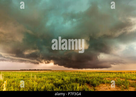 A large tornadic mesocyclone supercell inflow with a green glow of hail sucks in energy as it begins to transform into a tornado. Stock Photo