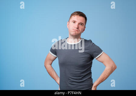 Indoor shot of serious middle aged european male frowns face, being offended by people who jokes at him Stock Photo