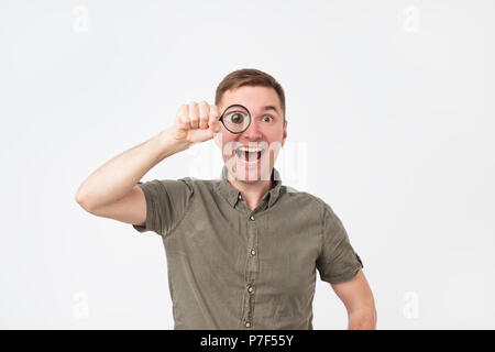 Funny european middle aged man holding magnifying glass portrait Stock Photo