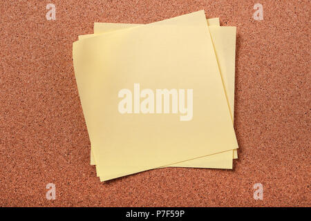 Several untidy sticky post notes on cork board Stock Photo