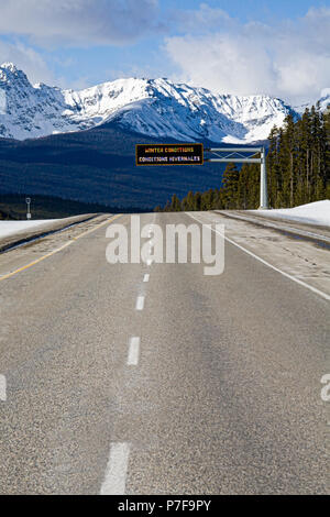 Winter conditions warning sign on Trans Canada Highway #1, Banff National Park, Alberta, Canada Stock Photo