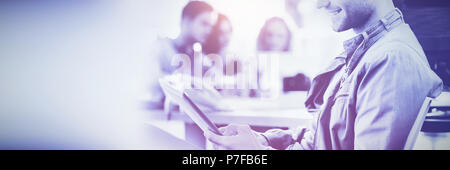 Smiling young man using digital tablet Stock Photo
