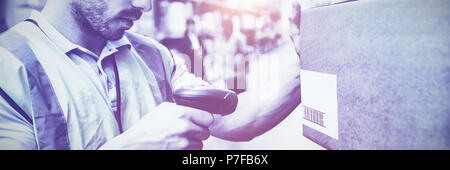 Worker scanning barcodes on boxes Stock Photo