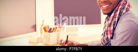 Portrait of smiling graphic designer using graphics tablet Stock Photo