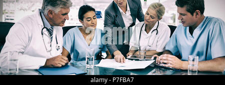 Team of doctors and businesswoman having a meeting Stock Photo