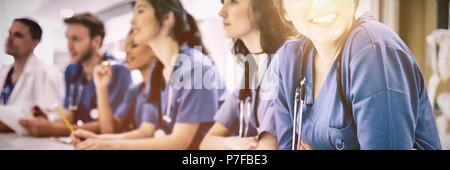 Student smiling at camera during class Stock Photo