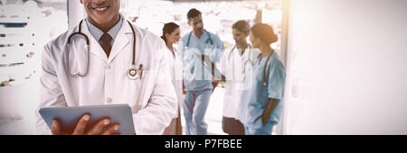 Smiling doctor holding digital tablet Stock Photo