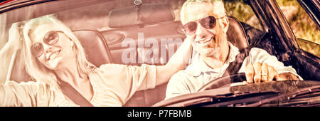 Happy mature couple in red cabriolet Stock Photo