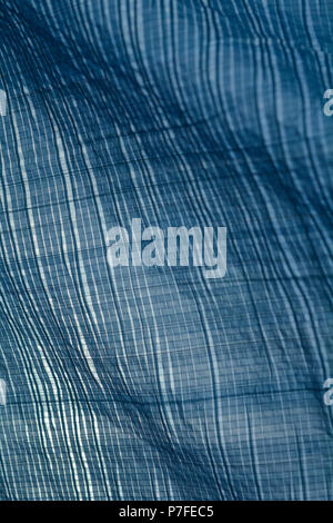 Monochrome plaid pattern of tarps in sunlight and wind creating a canopy and shade from the sun Stock Photo