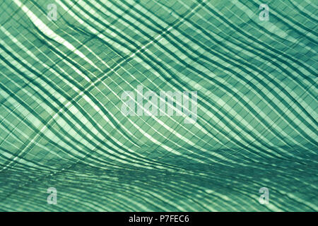 Monochrome plaid pattern of tarps in sunlight and wind creating a canopy and shade from the sun Stock Photo