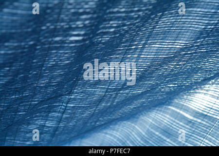 Monochrome plaid pattern of tarps in sunlight and wind creating a canopy and shade from the sun Stock Photo