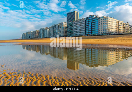 Reflection of Ostend City's cityscape in the North Sea with a view over the waterfront in summer, West Flanders, Belgium, Europe. Stock Photo