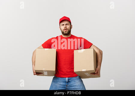 Exhausted handsome delivery man holding boxes and taking a break. Isolated on white Stock Photo