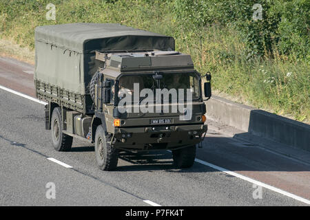 Canvas-covered MAN HX60 18.330 4x4 Army Shipping freight, Heavy Haulage military delivery trucks on the M6 at Lancaster, UK Stock Photo