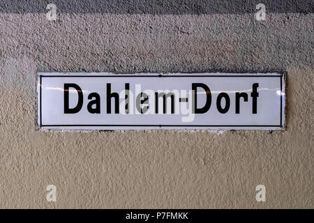 Berlin Dahlem-Dorf U-Bahn railway station sign on wall.Station was built in 1913 Stock Photo