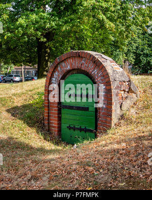 Berlin-Dahlem.Tiny green door leads to underground ice cellar built for the manor house opposite in Königin-Luise-Straße. Stock Photo