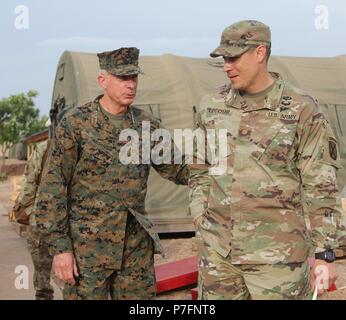 Maj. Lucas Lecour, commander of Task Force Darby at Contingency Location Garoua in Cameroon, welcomes General Thomas David Waldhauser of the United States Marine Corps and commander of United States Africa Command June 28, 2018. TF Darby service members are serving in a support role for the Cameroonian Military’s fight against the violent extremist organization Boko Haram. Stock Photo