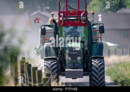 Newstead, Nottinghamshire, England. 6th. July 2018. UK. Weather. A farmer takes a cool drink in this tractor whilst delivering hay down a dusty farm track  as the hot and dry weather continues across all parts of the U.K.Alan Beastall/Alamy Live News