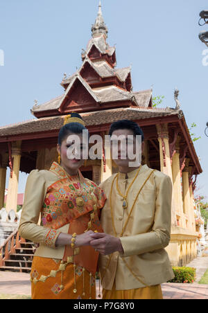 Bride and groom posing in front of Wat Si Saket, Vientiane, Laos, Asia. Stock Photo