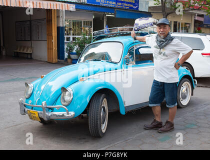 Portrait of senior man standing near old VW Beetle car, Vientiane, Laos, Asia. Stock Photo