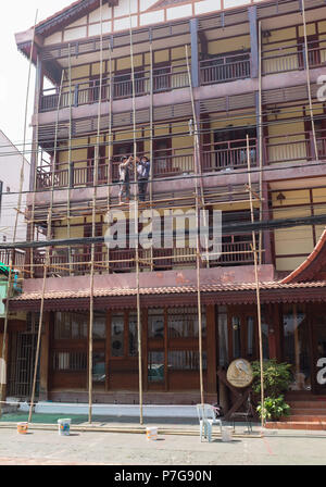 Workers working on bamboo scaffolding in Vientiane, Laos, Asia. Stock Photo