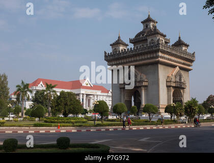 Patuxai monument in the centre of Patuxai Park and Prime Minister's Office building in the background, Vientiane, Laos, Asia. Stock Photo