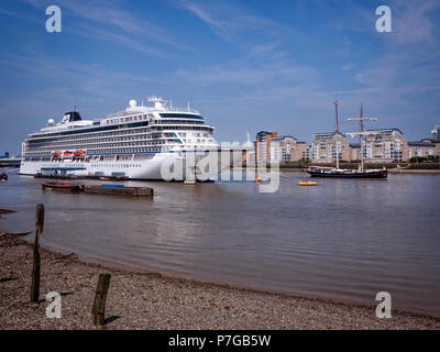 Cruise Liner Viking Sky moored uo at Greenwich London UK. Tall ship sailing past.