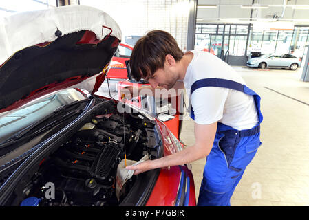 Oil level control of engine oil on the car by a professional mechanic Stock Photo