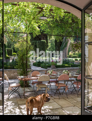 Table and chairs under pergola on terrace of 18th century chateaux, St Remy de Provence. Stock Photo